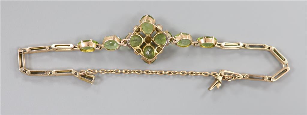 A late Victorian 9ct, peridot and seed pearl cluster set bracelet(adapted), approx. 16.5cm, gross 9 grams.